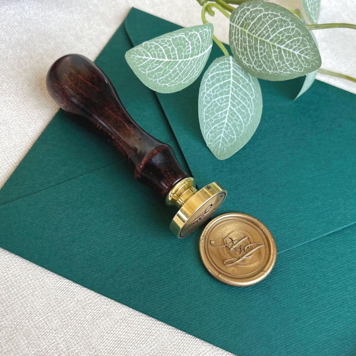 High-quality wax seal stamp with smooth wooden handles and precision-engraved custom initials.